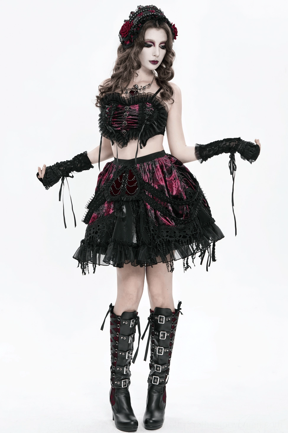 Close-up of wine red crushed velvet texture and black lace panel construction on gothic skirt