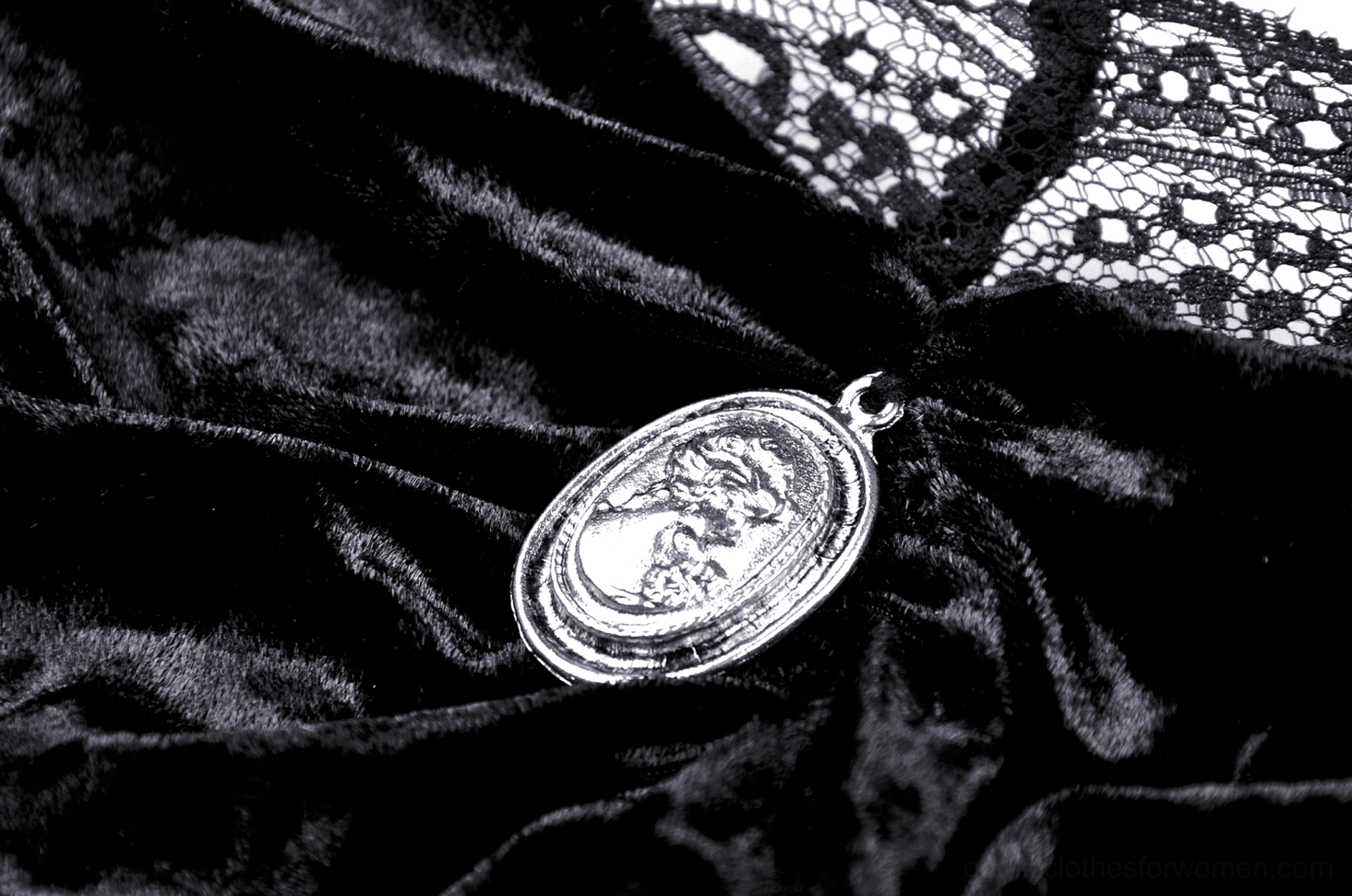 Gothic off-shoulder velvet top styled on model, showing cameo brooch and lace sleeve detail