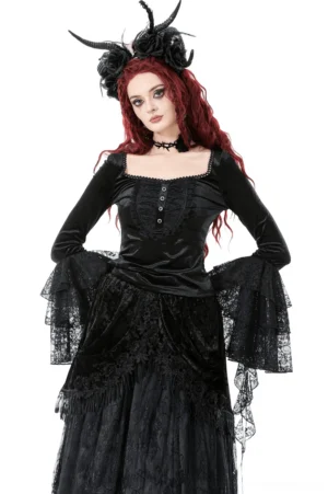 Black velvet gothic top with tiered lace bell sleeves front three-quarter view on model with red hair and horn headdress