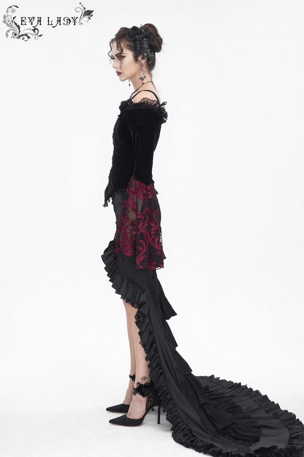 Side profile of model wearing black velvet gothic off-shoulder top with burgundy lace