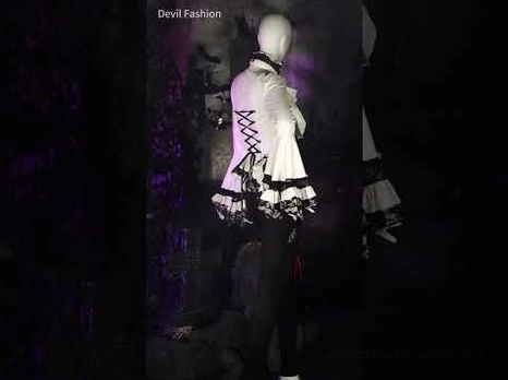 Side rear view of gothic Victorian blouse on display mannequin showcasing back corset design with black and white two-tone styling