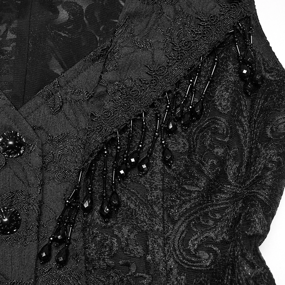 Close-up detail of gothic waistcoat shoulder trim with beaded tassel decorations and embroidered lace