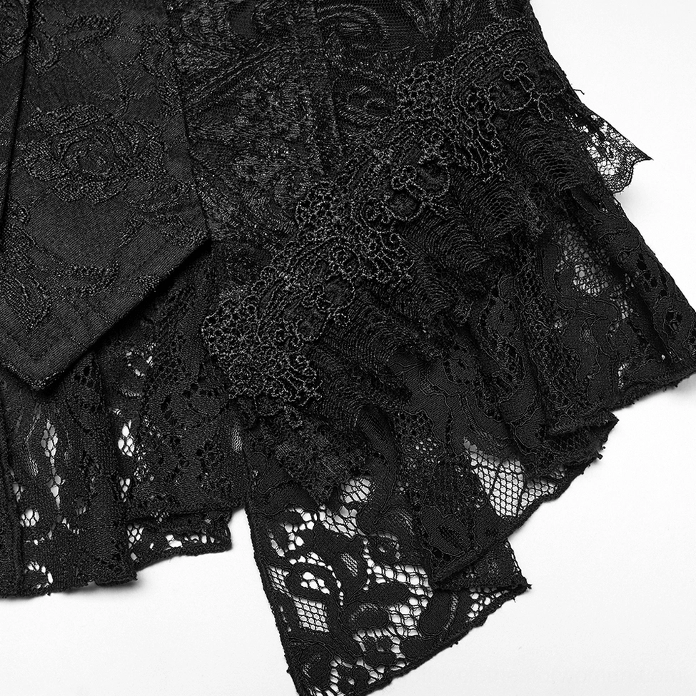 Close-up detail of gothic waistcoat layered ruffle lace hem showing asymmetric high-low construction