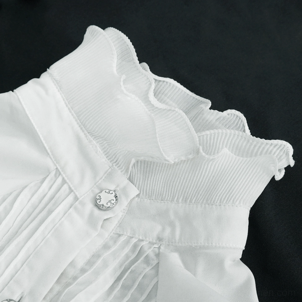 White gothic blouse detail shot showing button hardware, floral embroidery work, and ruffled edge texture