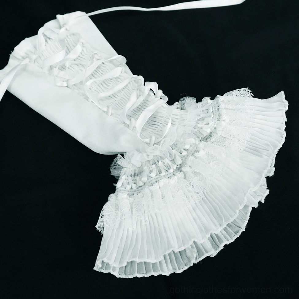 White gothic sleeveless blouse showing full silhouette fit and proportion on mannequin with visible embroidery and button details