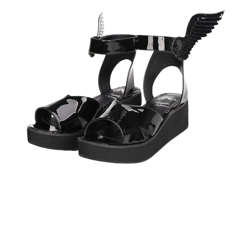 Black winged platform sandals three-quarter front view showing patent leather, angel wing ankle strap embellishment, and thick EVA sole
