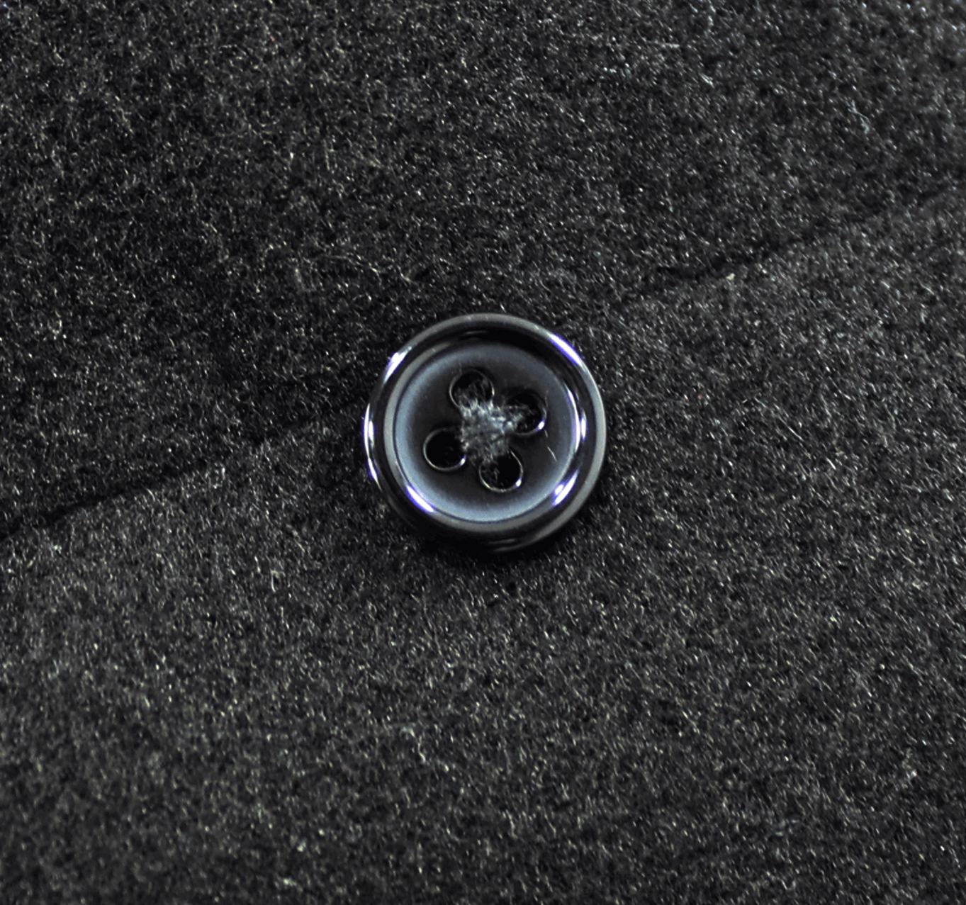 Product detail photography of gothic winter coat showing layered construction, faux fur accents, buckled cuff system, and overall construction quality