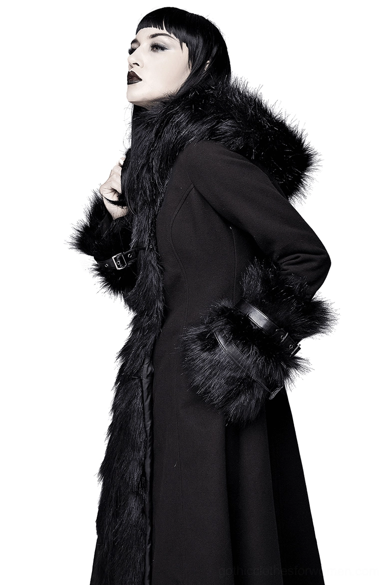 Side three-quarter view of gothic long coat showing faux fur hood, front fur panel detail, and buckled leather cuffs on alternative fashion model