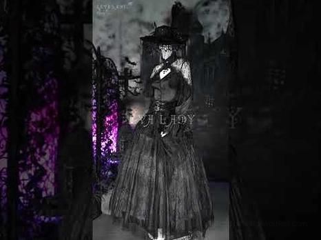 Female model wearing black gothic lace skirt with wide brim hat in dark haunted gothic interior setting