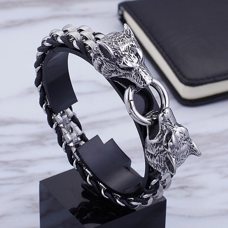 3/4 close-up view of gothic wolf head bracelet showing dual wolf head ends and intricate carving details on display stand