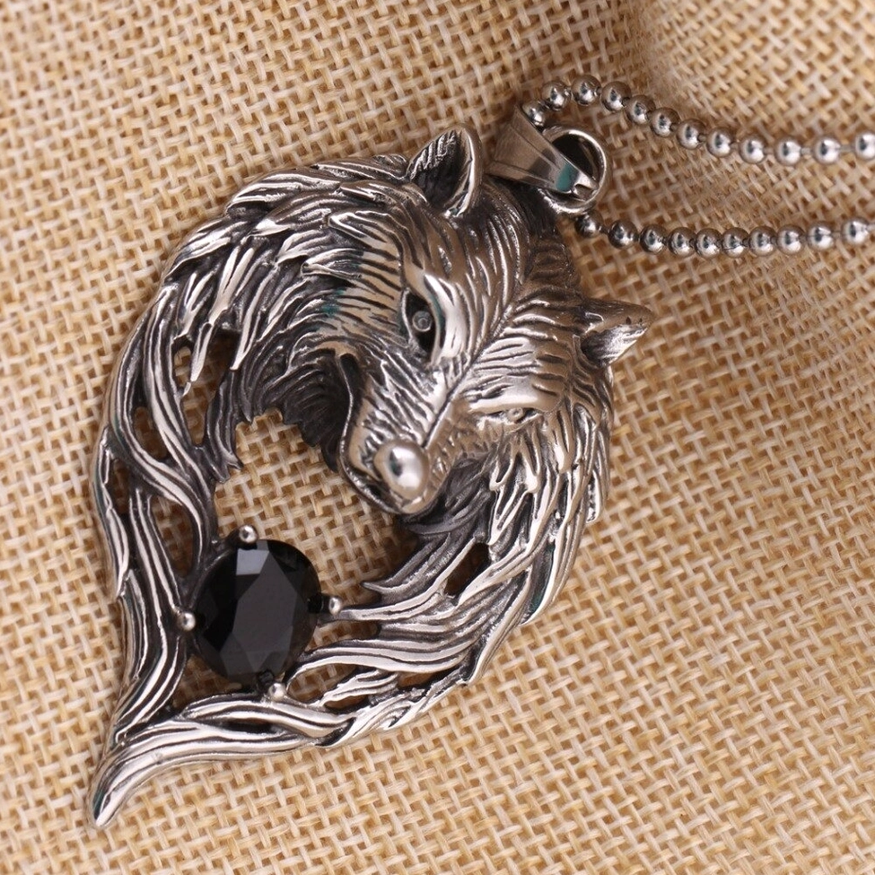 Gothic wolf head pendant necklace on ball bead chain displayed on linen fabric, side flat lay perspective