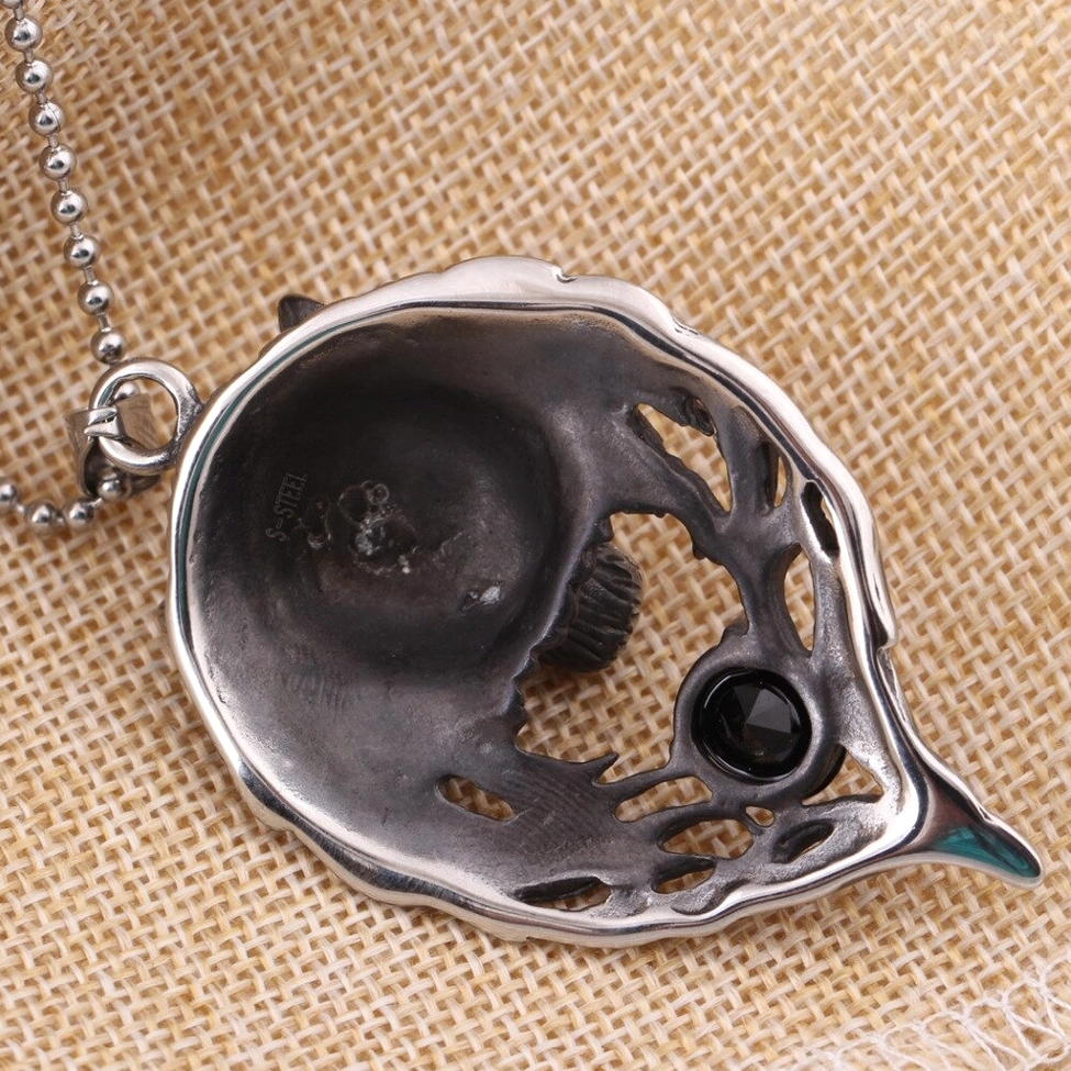 Back view of gothic wolf head pendant on ball bead chain showing hollow interior and craftsmanship details