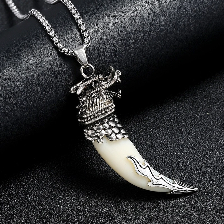 Mixed wolf tooth pendants on dark display - dragon and wolf head gothic metal designs antique silver finish
