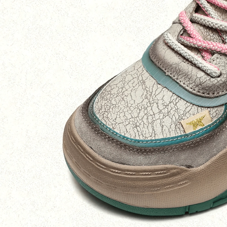 Gray gothic platform boots showcasing patchwork design with beige and turquoise ethnic elements and elevated rubber platform