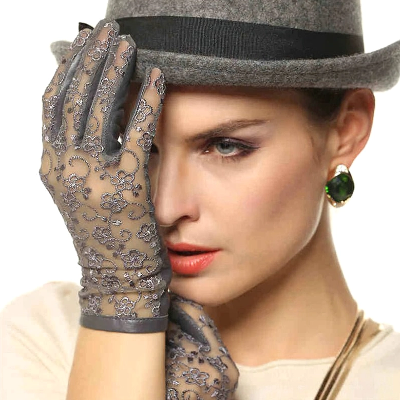 Grey floral lace gothic gloves with leather trim, model with fedora hat, upper body front view, dark aesthetic styling