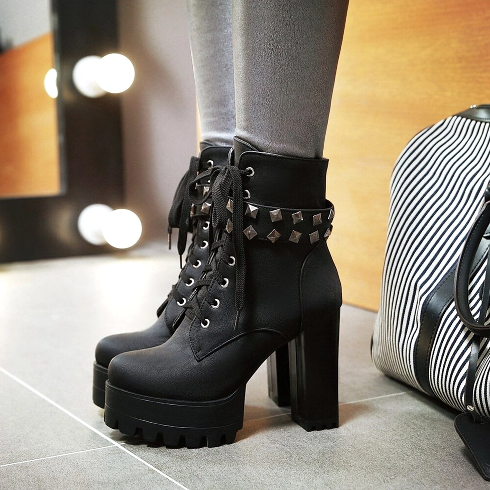 Grey gothic platform combat boots with matte suede texture, three-quarter view showing heel structure
