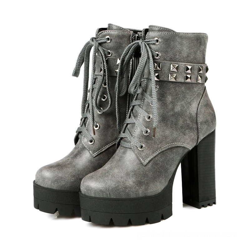 Grey suede gothic platform combat boots with matte finish and studded accent strap