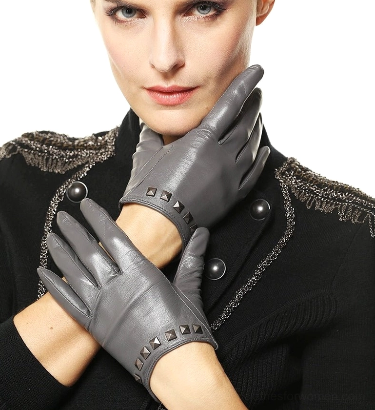 Grey studded leather women's gloves with gothic wrist rivets, close-up side view