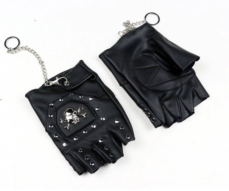 Half-finger leather gloves detail shot showcasing metal skull emblem rivets and gothic chain design elements