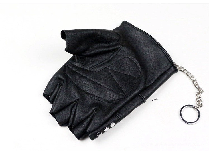 Single black half-finger punk glove flat lay with cuff rivets and chain key ring accessory - side view