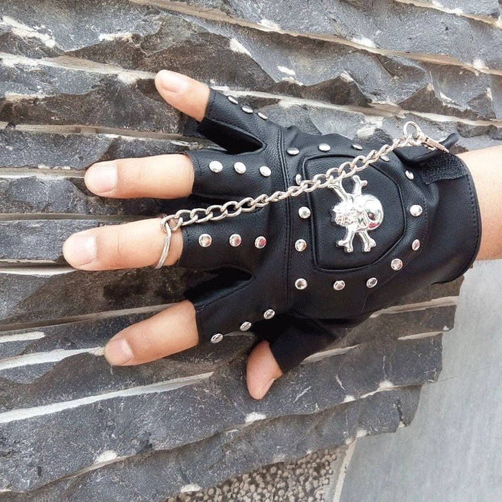 Half-finger skull gloves with metal rivets and gothic chain accessory - alternative fashion styling