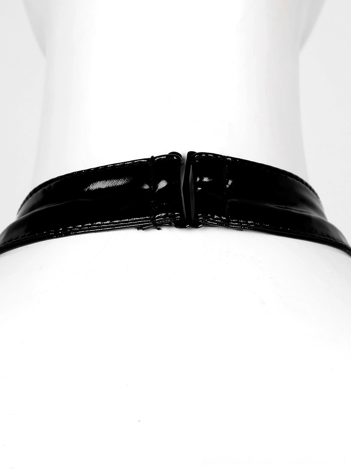Halter neck collar detail of gothic bodysuit showing patent leather strap, buckle closure, and O-ring hardware