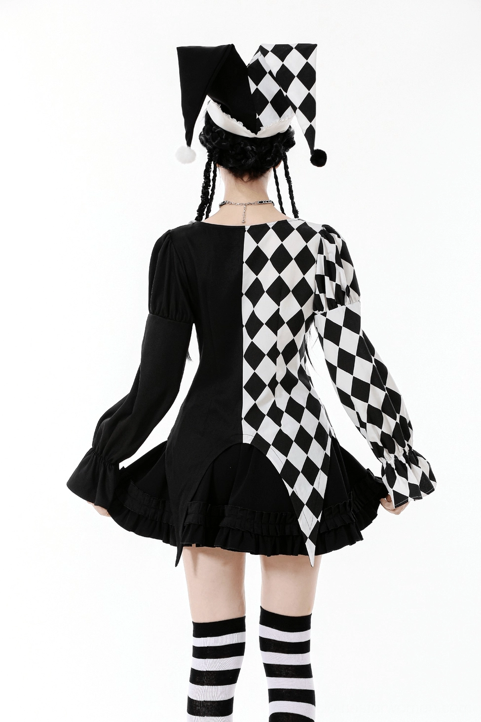 Black and white harlequin jester hat showing playful pompom design and theatrical silhouette