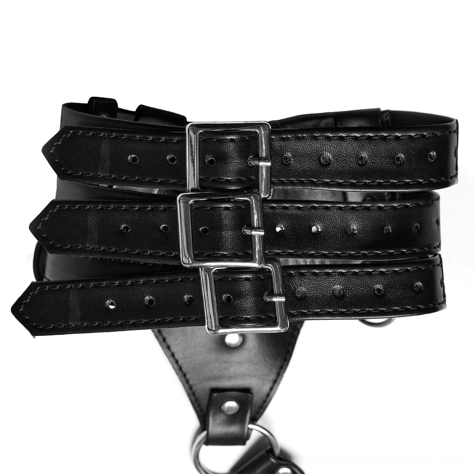 Close-up detail of triple-layer harness buckle straps with silver metal buckles and protective rivets on black PU leather