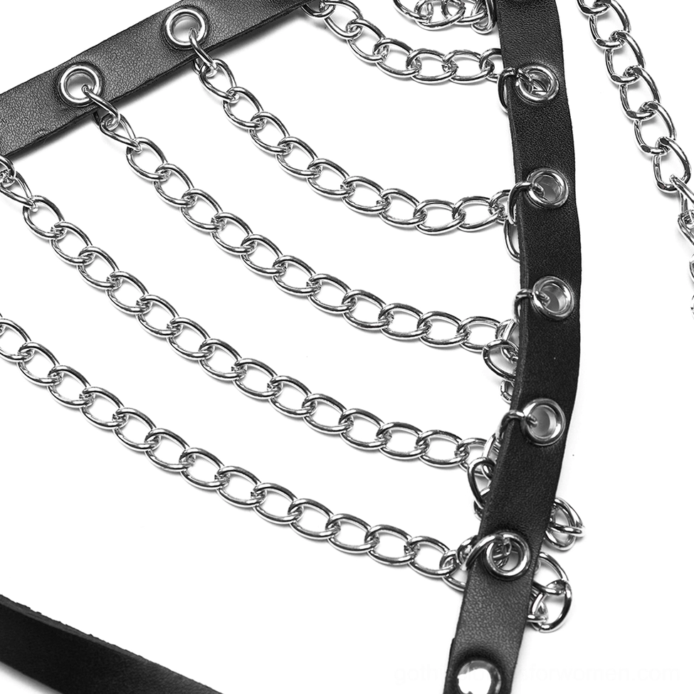 Close-up of black leather straps, silver metal chains, and metal grommets on harness