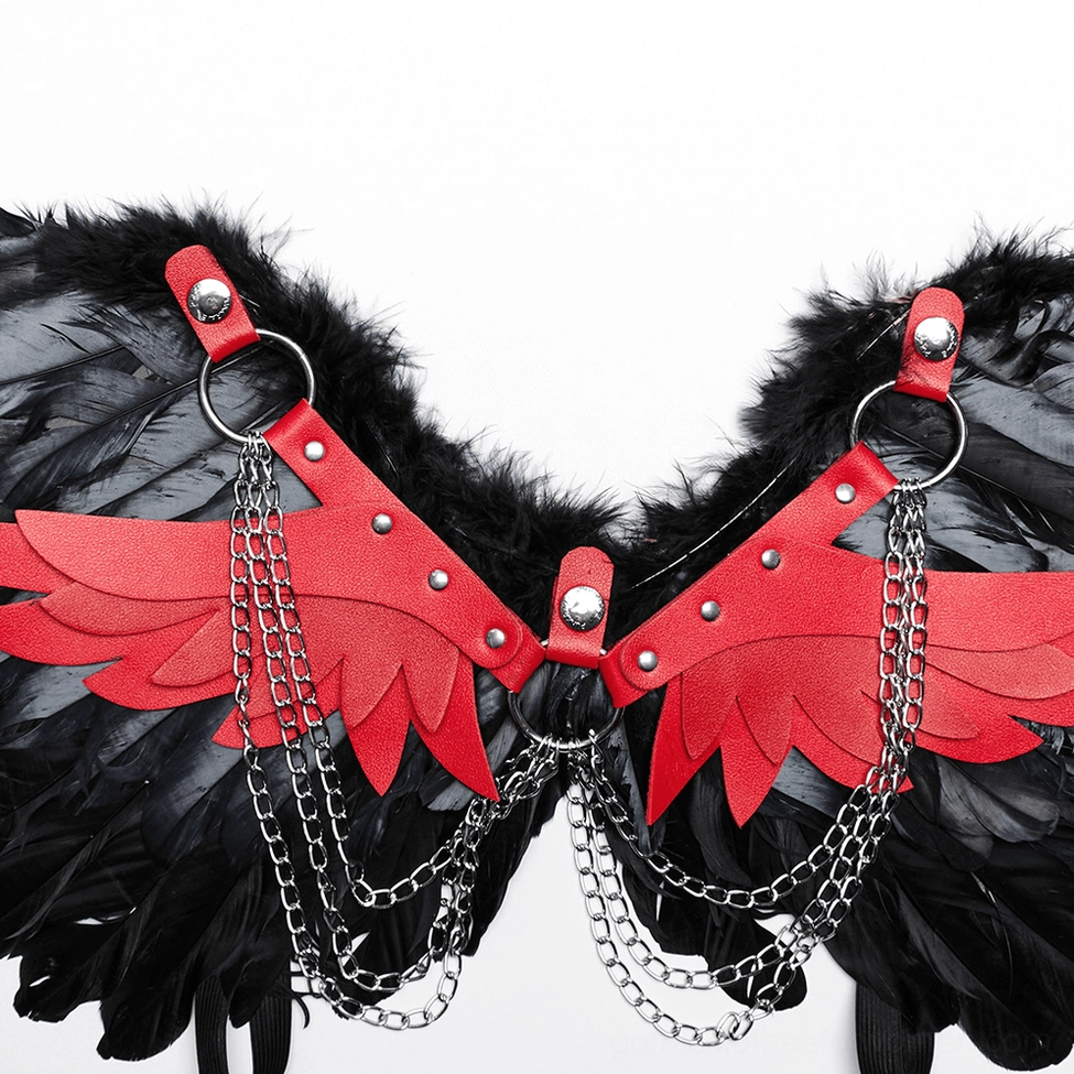 Close-up detail of red leather harness straps with silver metal rings and decorative chain hardware