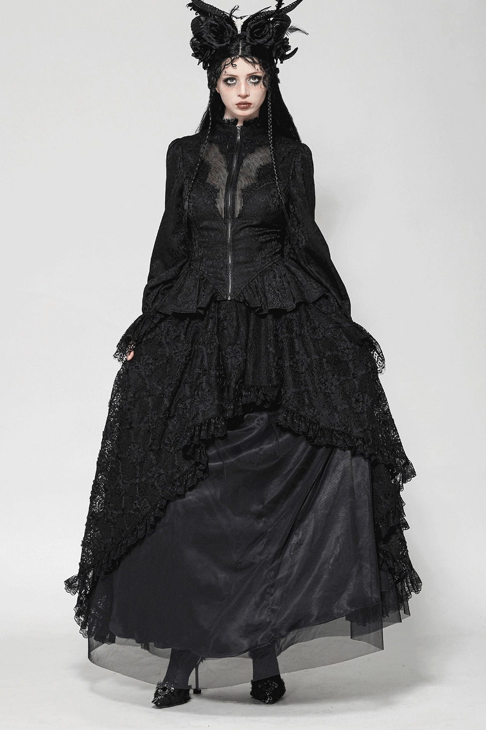 Black high-low lace tailcoat detail featuring intricately layered lace tails and structured silhouette
