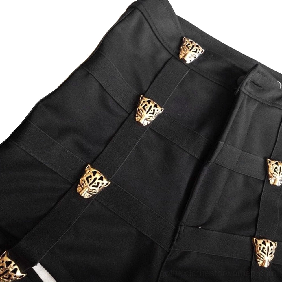 Close-up front detail of black high-waist shorts highlighting gold leopard metal button decorations