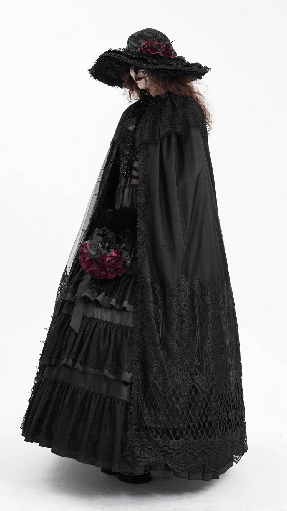 Front full-body photograph of black hooded gothic cape with lace embroidery and mesh details on cosplayer model