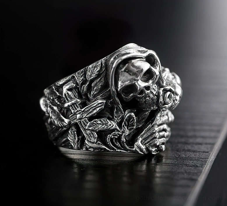 Hooded grim reaper skull ring with rose and foliage carved details, vintage silver patina on wooden surface