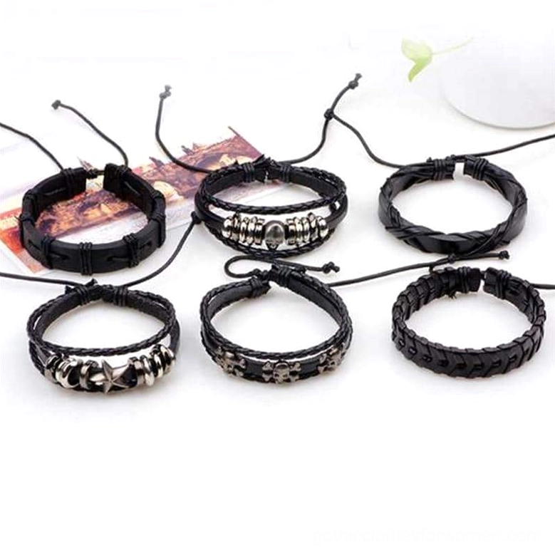 Single punk leather gothic bracelets with skull metal decorations and adjustable pull-tie mechanism displayed on decorative table surface