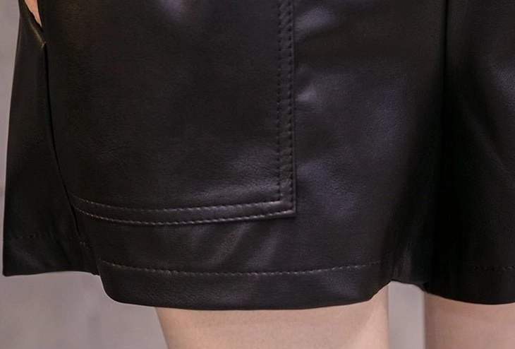 Khaki PU leather high-waist shorts with functional pockets and adjustable belt, full front view