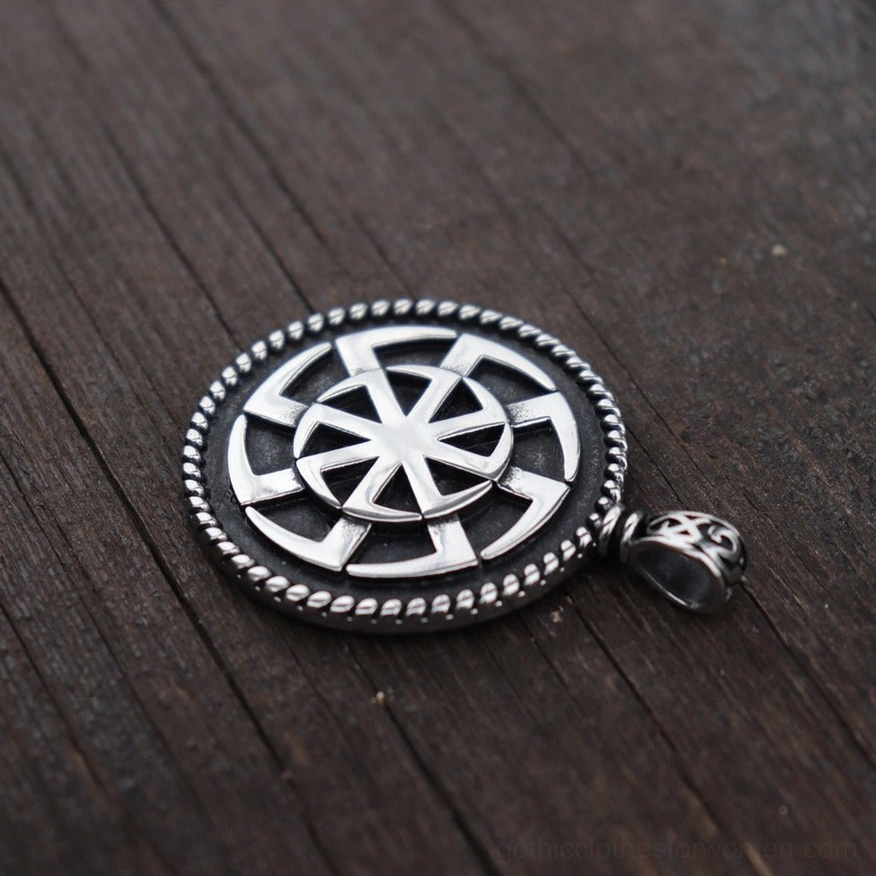 Kolovrat pendant unstrung angled view - braided metal rim and decorative bail close-up