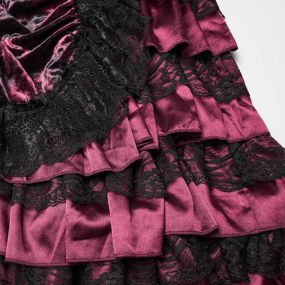 Lace ruffled hem detail close-up showing black eyelash lace overlay with tiered satin ruffles on gothic skirt