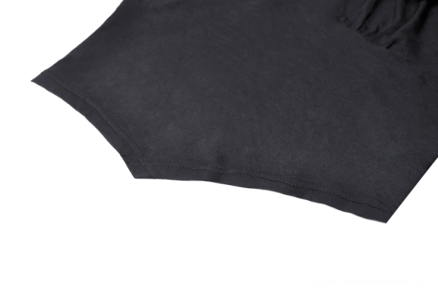 Bodice fabric close-up showing solid black stretch knit with curved hemline design