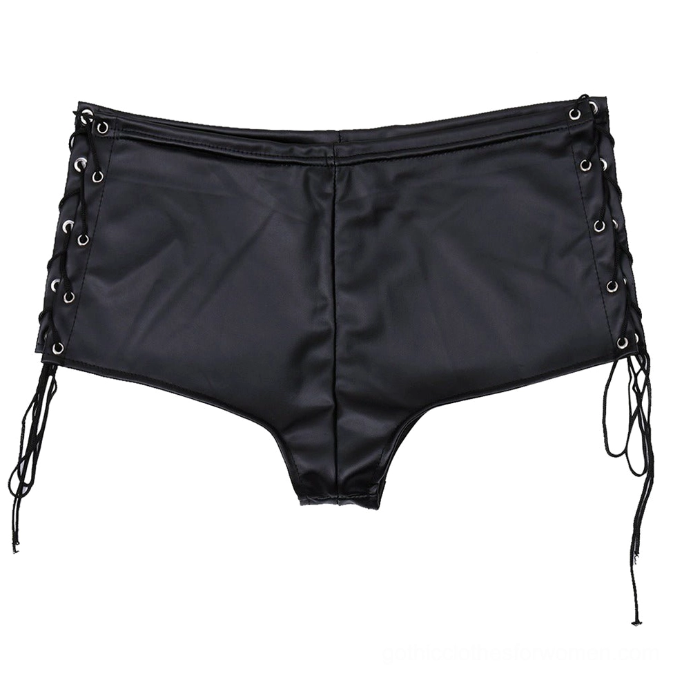 Flat-lay overhead view of black patent leather shorts with metal eyelet lace-up sides and high waist design