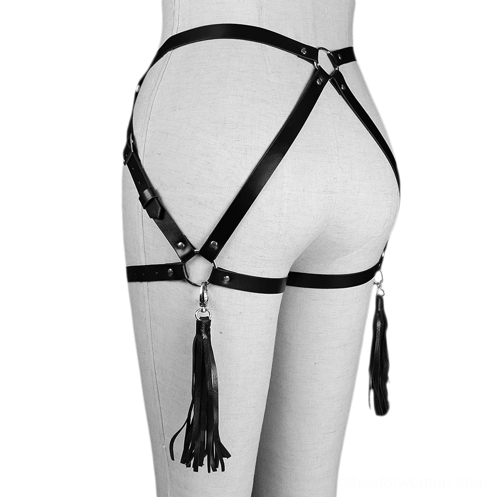 Black synthetic leather harness right rear view on mannequin showing single tassel pendant, adjustable metal O-ring fasteners, and strap positioning details