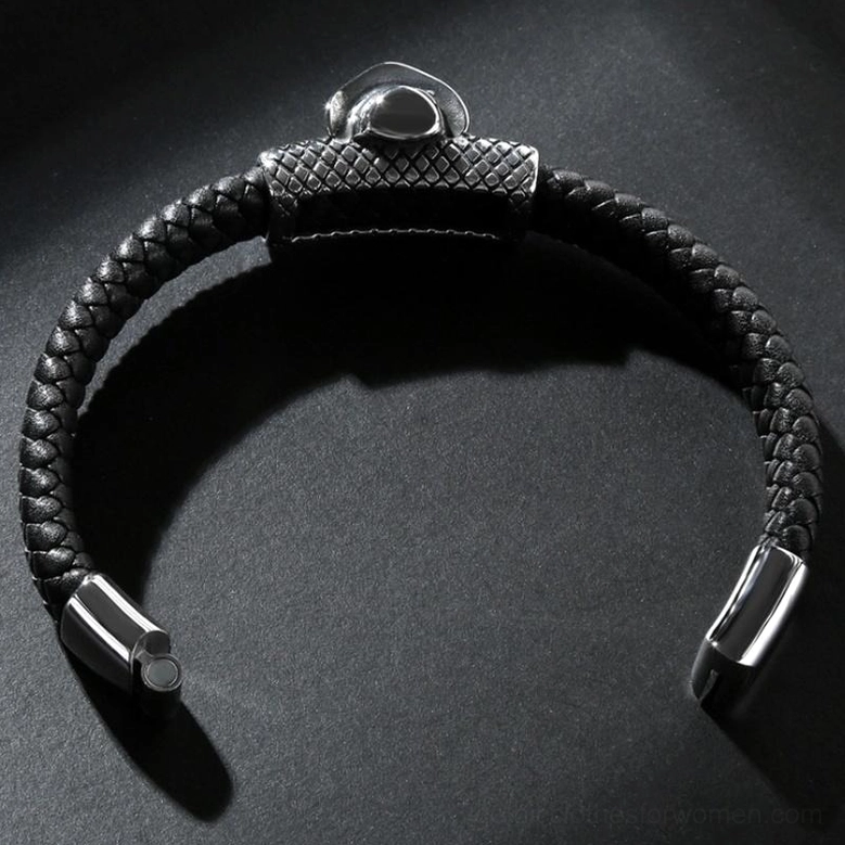 Overhead flat lay of black braided leather gothic bracelet showing magnetic metal clasp, polished hardware, grid-textured metal accent, and overall unisex design on neutral background