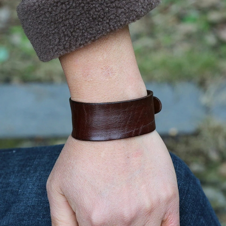 Wide leather gothic bracelet worn on wrist outdoor casual punk fashion styling