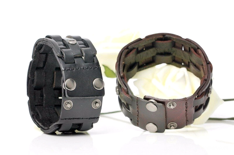Mixed-color gothic leather wrap bracelets flat lay view with decorative flowers, highlighting visible snap adjustment holes and industrial metal fasteners