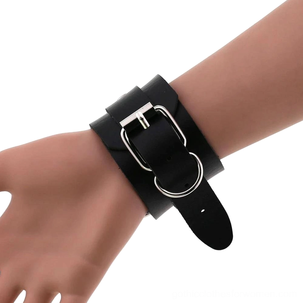 Various color leather gothic cuff bracelets arranged flat lay, unisex alternative fashion jewelry selection