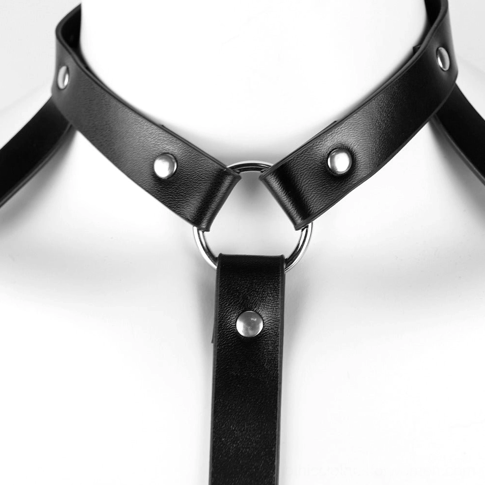 Close-up detail of black leather harness neck strap with silver rivets and hardware, highlighting craftsmanship and material quality