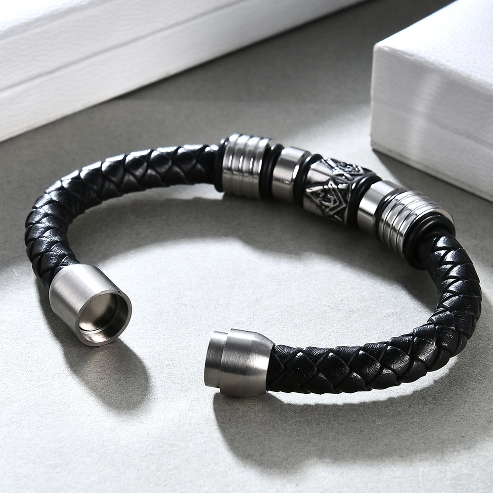 Braided black leather Masonic bracelet on display with exposed magnetic joint and embossed emblem accent