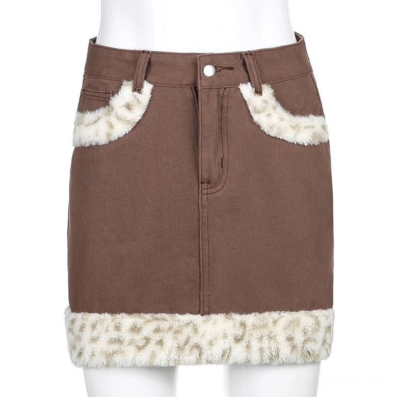Gothic edge denim mini skirt detail shot, leopard faux-fur trim texture close-up
