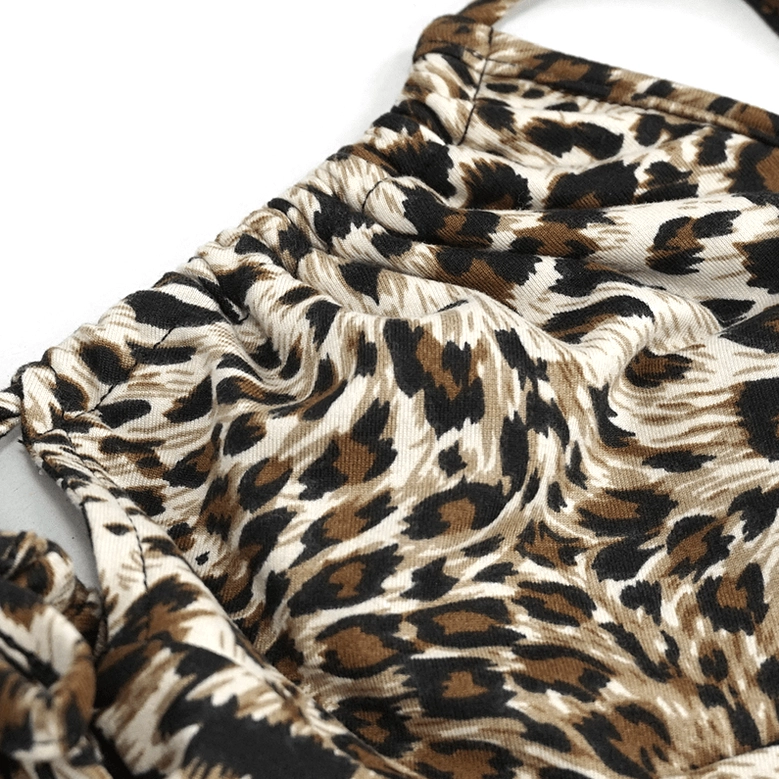 Leopard print bikini fabric texture close-up, displaying classic animal print pattern and soft stretchy knit material composition