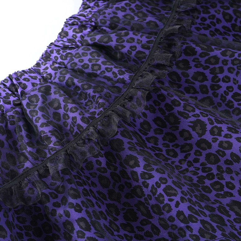 Close-up of purple leopard print fabric texture and black lace trim embellishments on gothic skirt